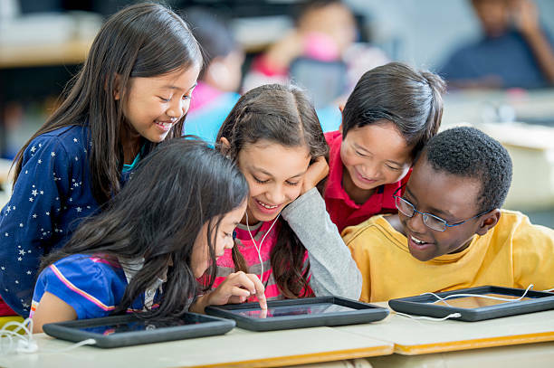 students playing on tablet